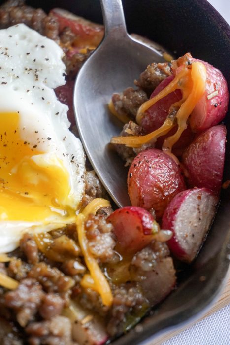 Keto Breakfast Bowl! Perfectly roasted radishes topped with sausage, cheese and a perfectly cooked egg!