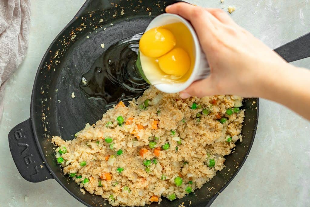 Cauliflower Fried Rice adding the eggs in separately to cook them before mixing