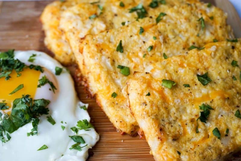 cauliflower hash browns next to a sunny side up egg