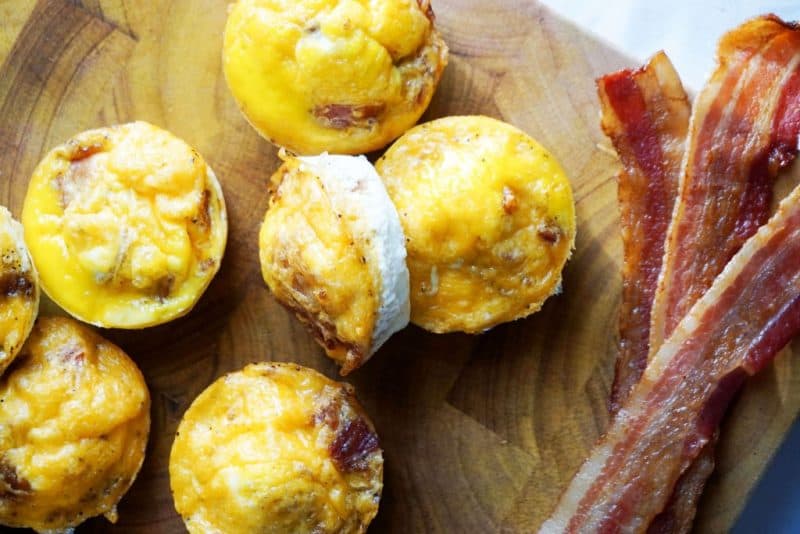 bacon egg cups bacon egg cups and cooked bacon on a wooden cutting board a great recipe for keto on a budget