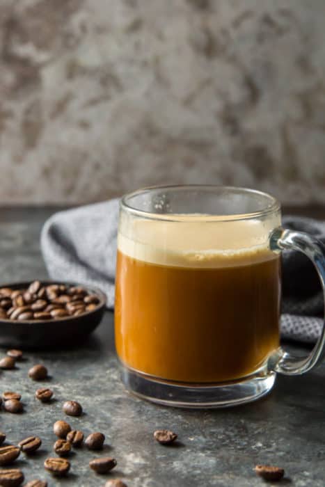 cup of coffee on a table with butter