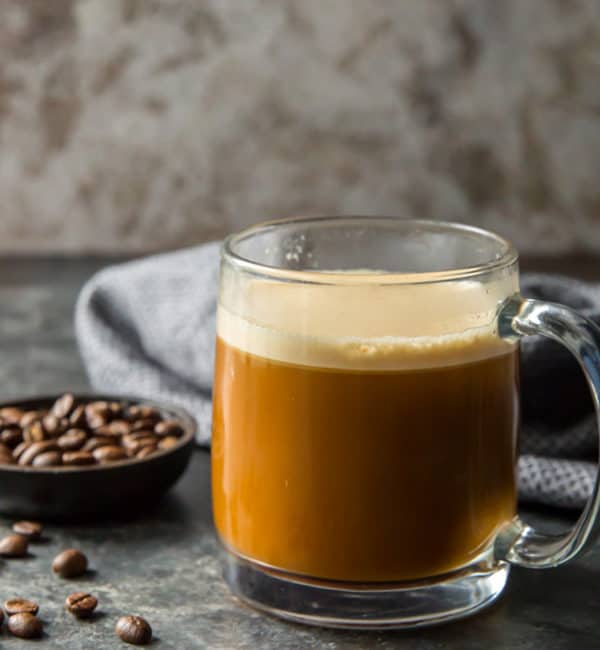 Bulletproof Coffee cup of coffee on a table with butter