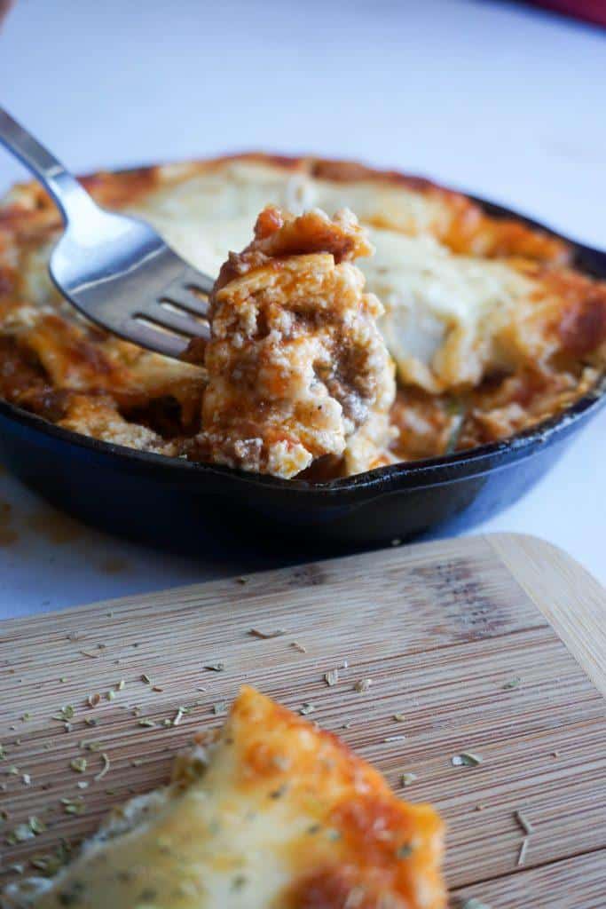 Digging into keto lasagna with silver fork