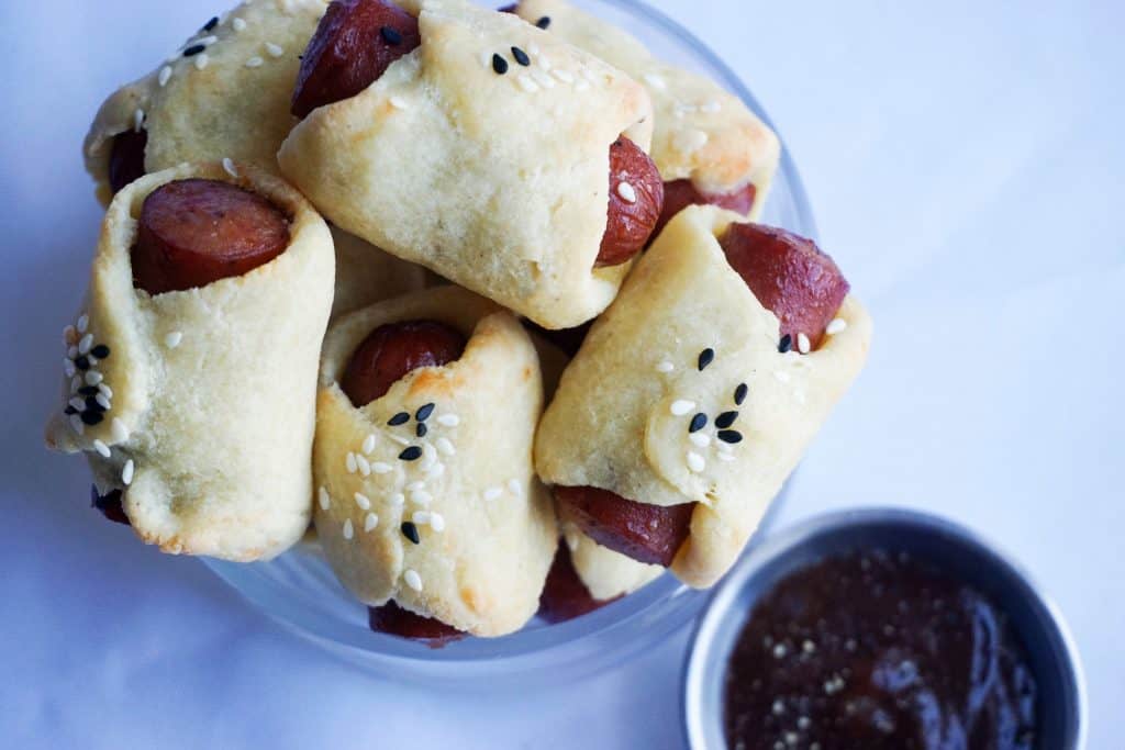 high fiber muffins batter keto pigs in a blanket next to BBQ sauce