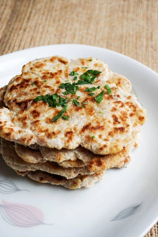 keto naan stack of low carb keto naan on a plate with butter