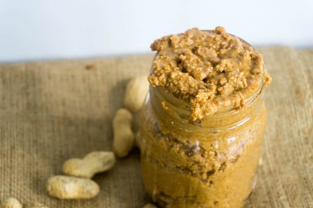 freshly ground peanuts in a mason jar