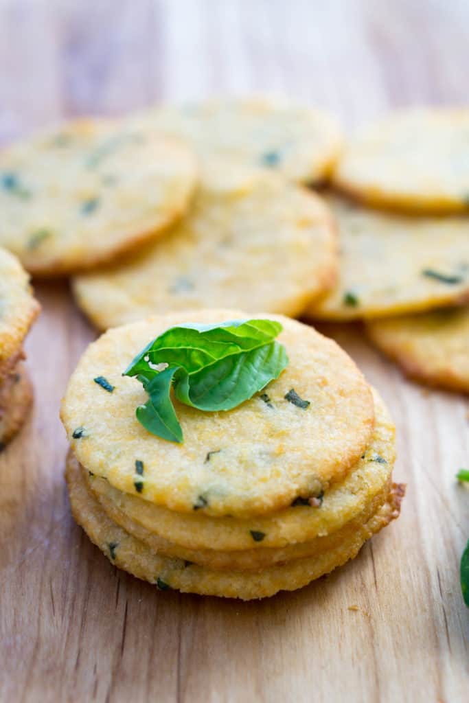 cheese crackers with fresh basil on top
