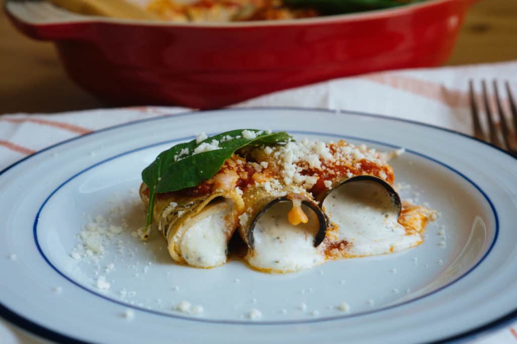 eggplant manicotti being plated and served