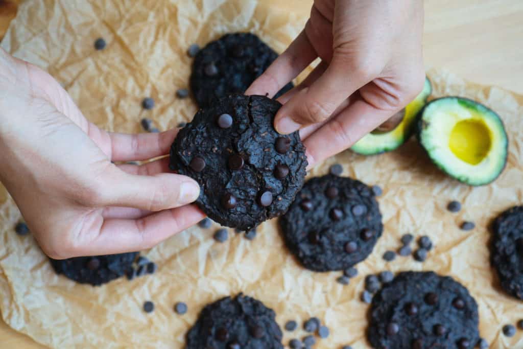 two hands breaking apart a dairy free keto fudge cookie