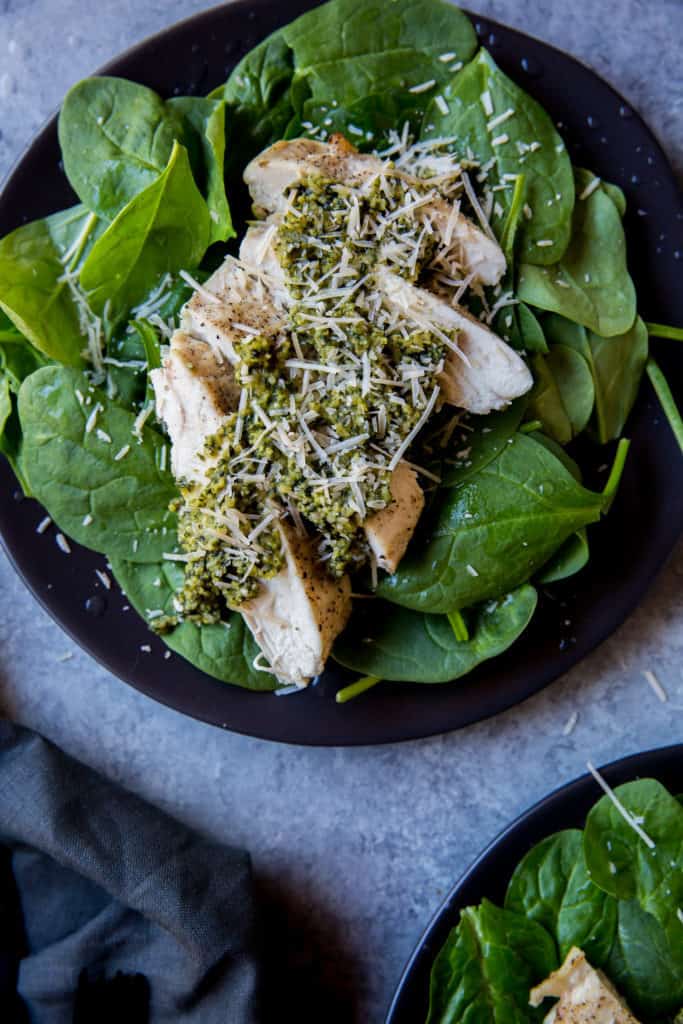 Our Pesto Chicken Recipe Finished pesto layered on sliced chicken breast