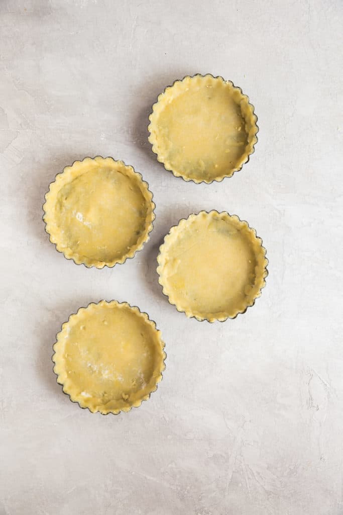 keto pie crust formed into tart pans which makes it easier to remove after baking