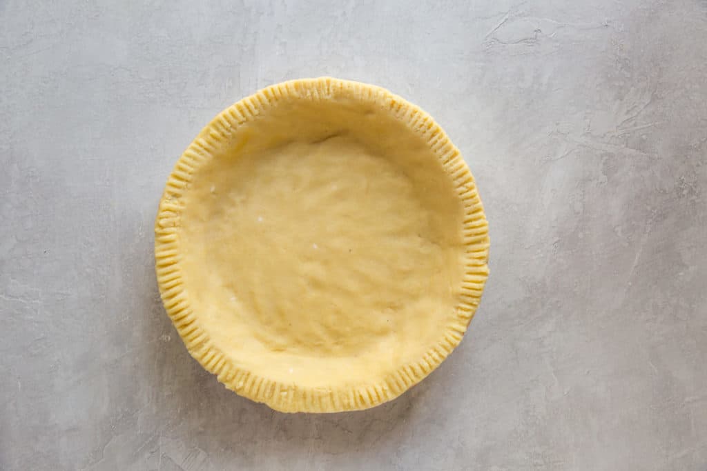 keto pie crust before being baked that is formed to a pie pan