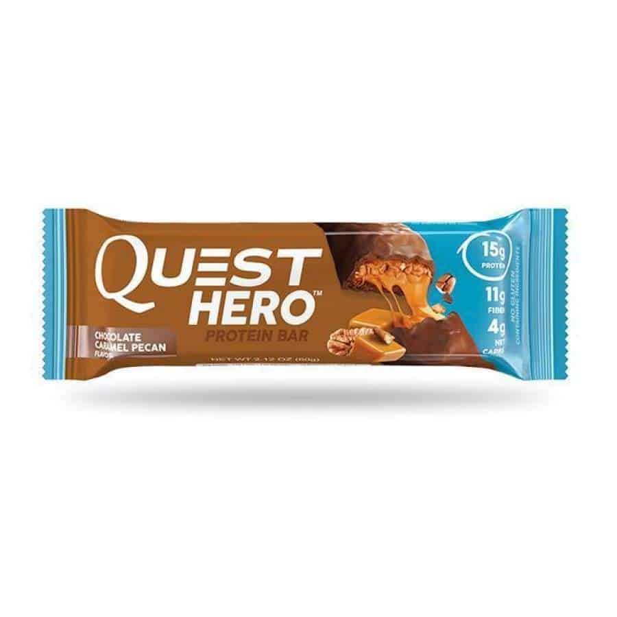 chocolate caramel pecan protein bar in packaging against a white background