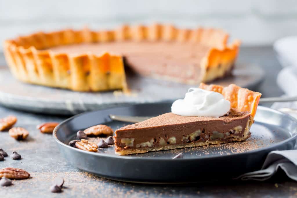 Keto pecan chocolate tart sliced and served on a plate