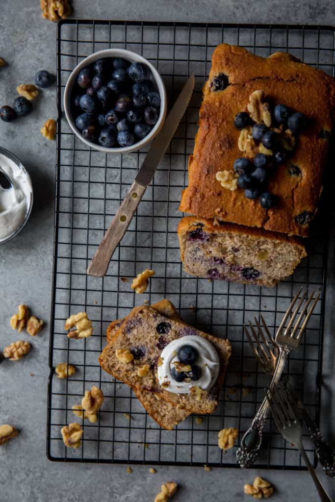 vertical image of blueberry walnut pound cake
