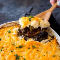 keto shepherd's pie scooping a serving out of a keto shepherds pie