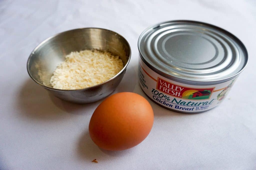 These three simple ingredients are all it takes to make delicious chicken crust. Parmesan cheese, shredded chicken, and an egg. 