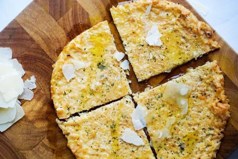 This frozen chicken crust pizza has a three-ingredient pizza crust is a homemade pizza option that only takes three ingredients to make. The pizza crust can be made with shredded chicken, parmesan cheese, and an egg which can then be baked and frozen.