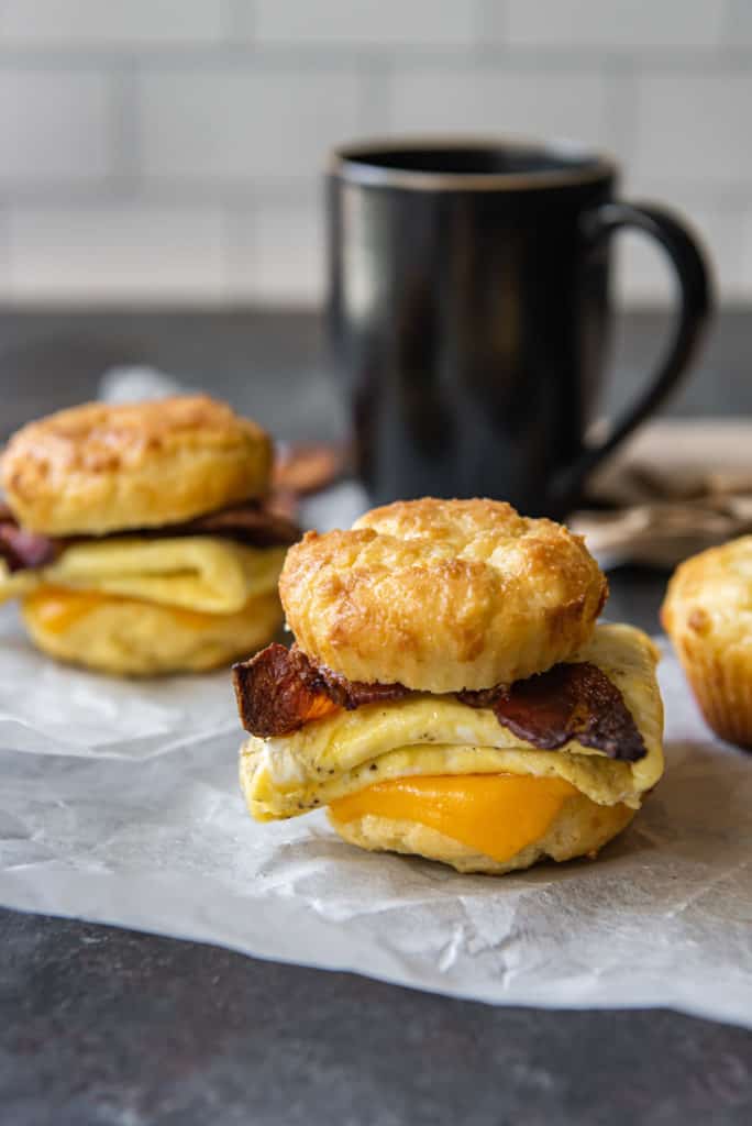 keto breakfast sandwich breakfast biscuit sandwich with coffee cup in background