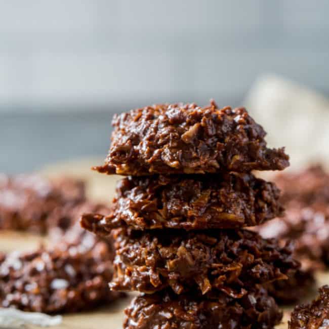 Keto No Bake Cookies chocolate keto no bake cookies stacked on top of each other with pecans in the background
