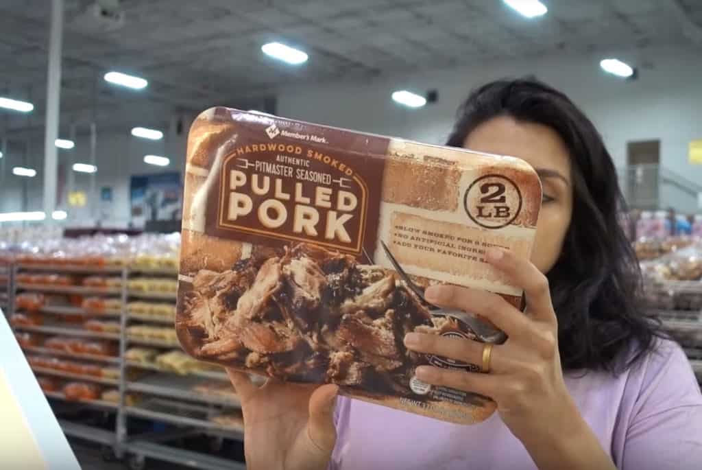 sams club keto A woman holding a package of fully cooked pulled pork at Sam's Club.