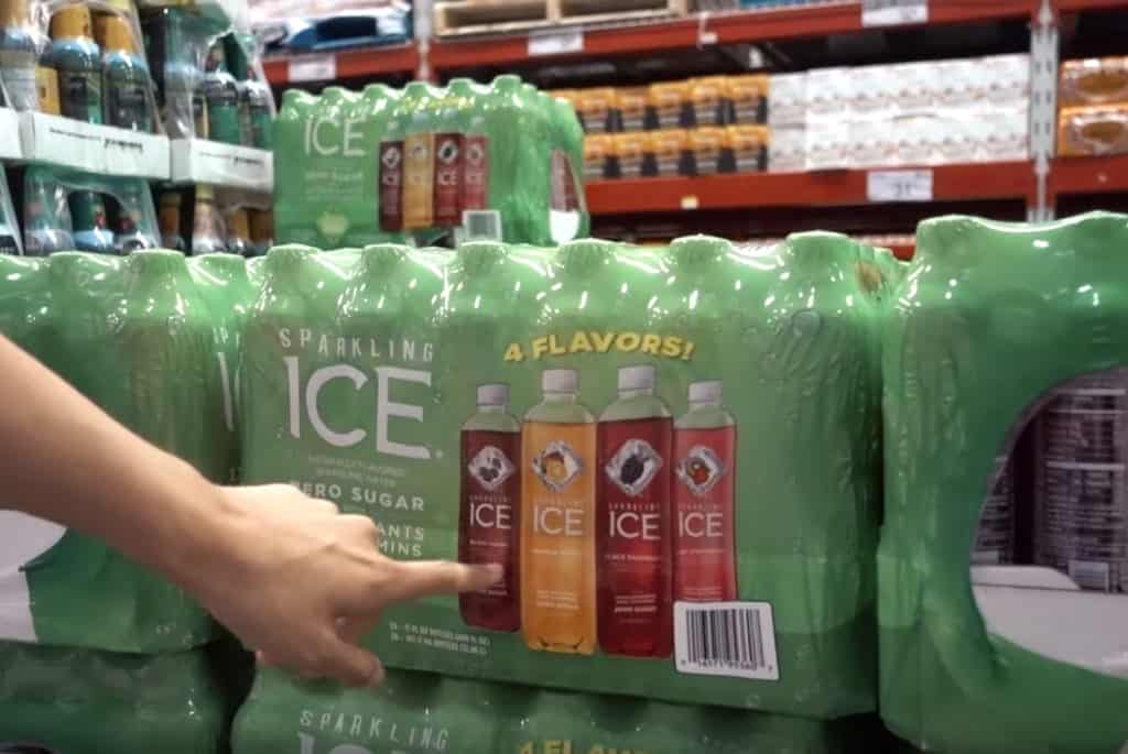 A woman's hand pointing to a bulk pack of Sparkling Ice zero-calorie sodas on sale at Sam's Club.