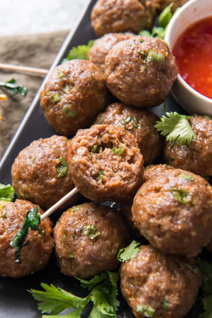 air fryer meatballs meatballs on a rectangle plate with a bite out of one of them