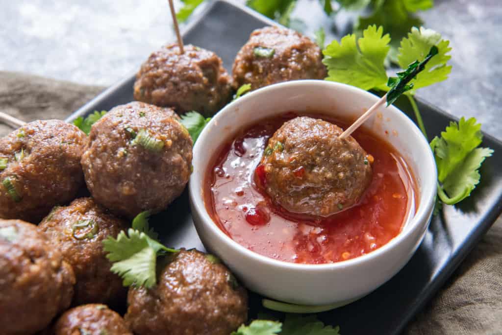 air fryer meatballs being dipped