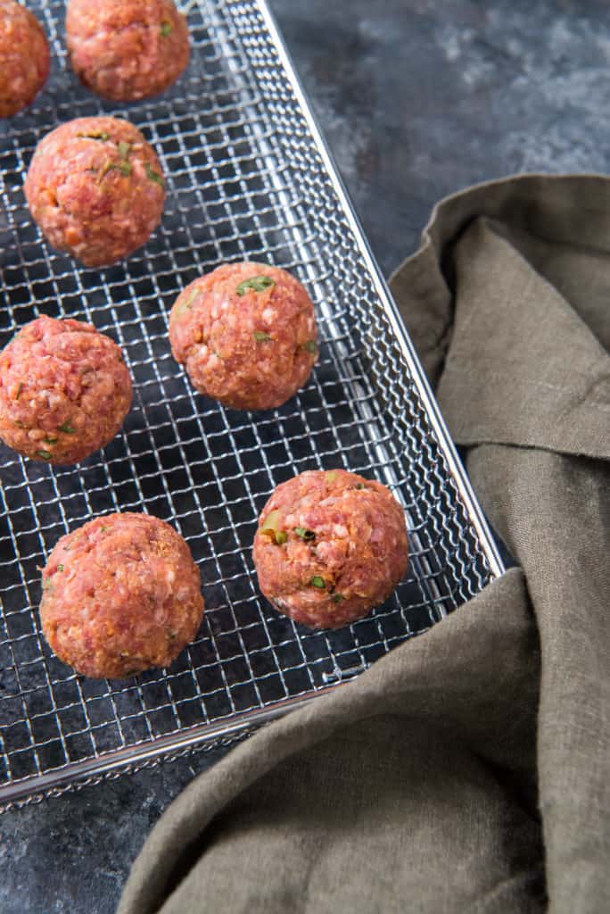 air fryer meatballs formed onto a baking sheet