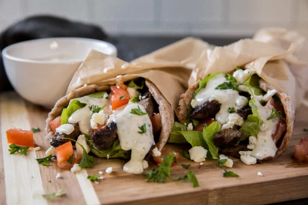 Healthy Gyros two gyros with yogurt sauce for dipping.