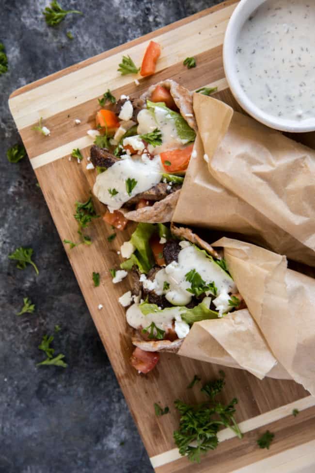 two healthy gyros on a cutting board