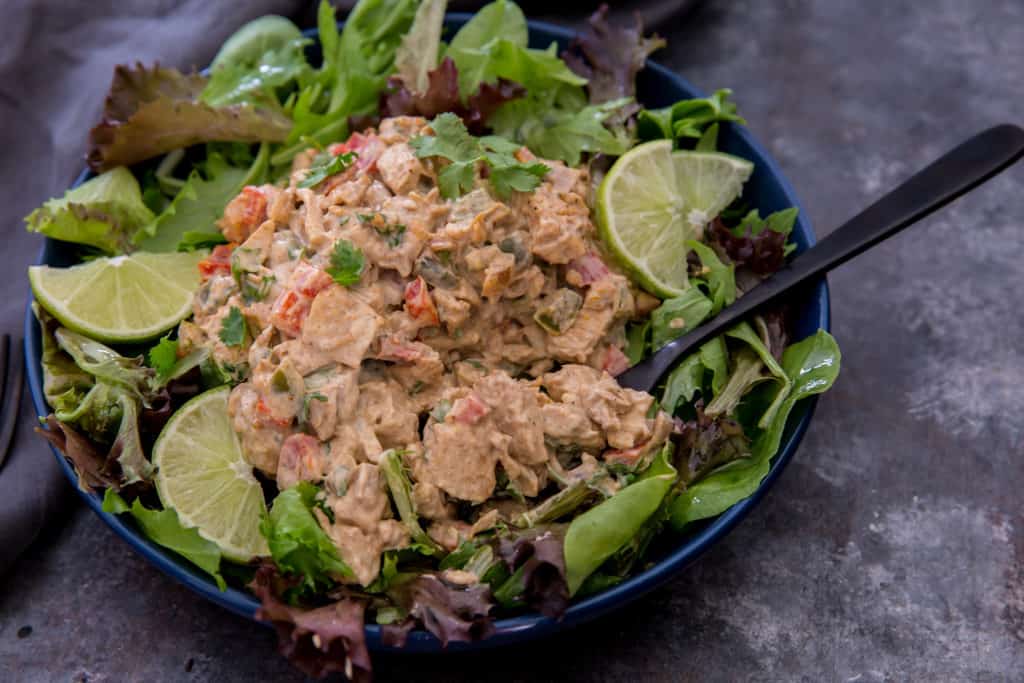 keto chicken salad fajita style keto chicken salad on top of a bed of lettuce with a fork