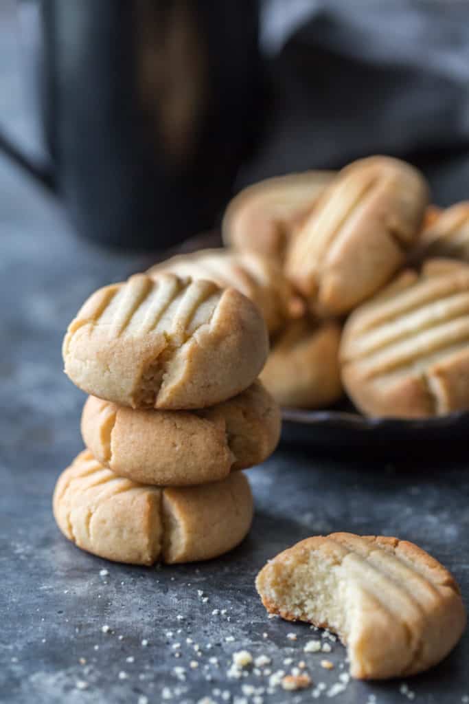 A stack of fresh butter cookies starting to be eaten 