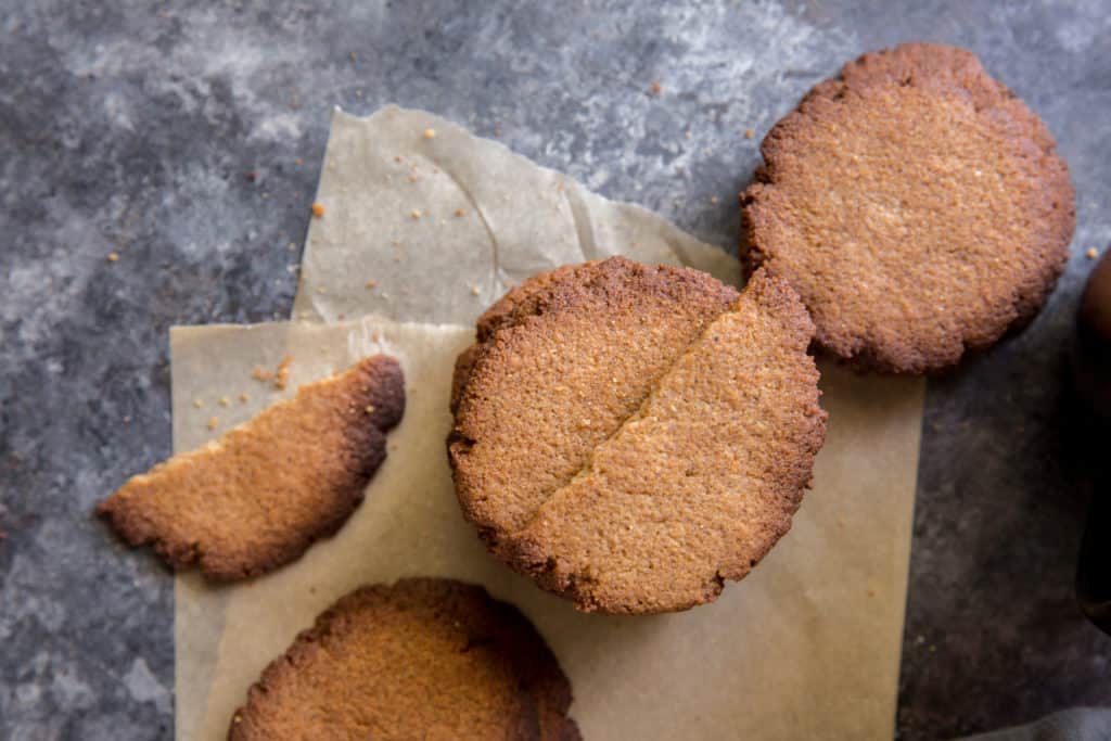 keto ginger cookies three stacks of keto ginger cookies on a piece of parchment paper