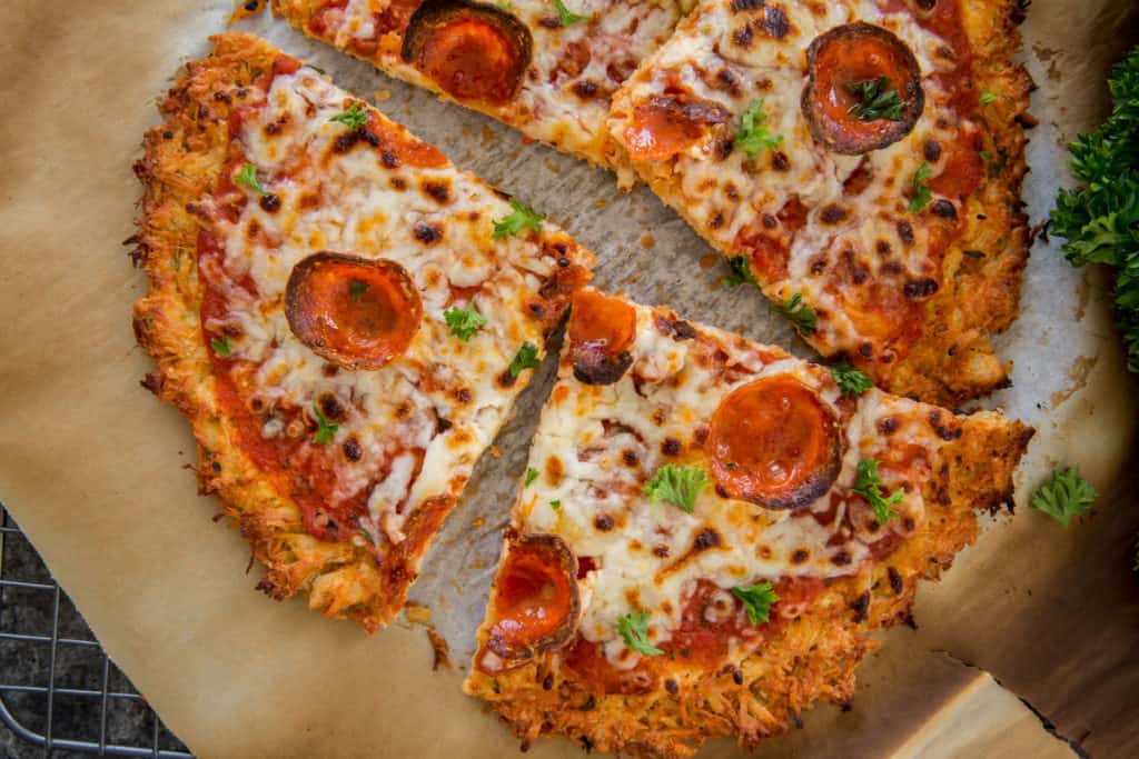 chicken crust pizza pizza sliced into pieces