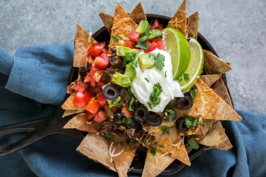 keto nachos with low carb tortilla chips served in a cast iron skillet