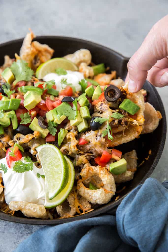low carb rolls cut horizontal A hand reaching for keto pork rind nachos