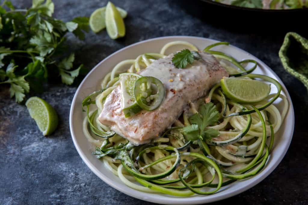 keto salmon curry served over zucchini noodles on a white plate
