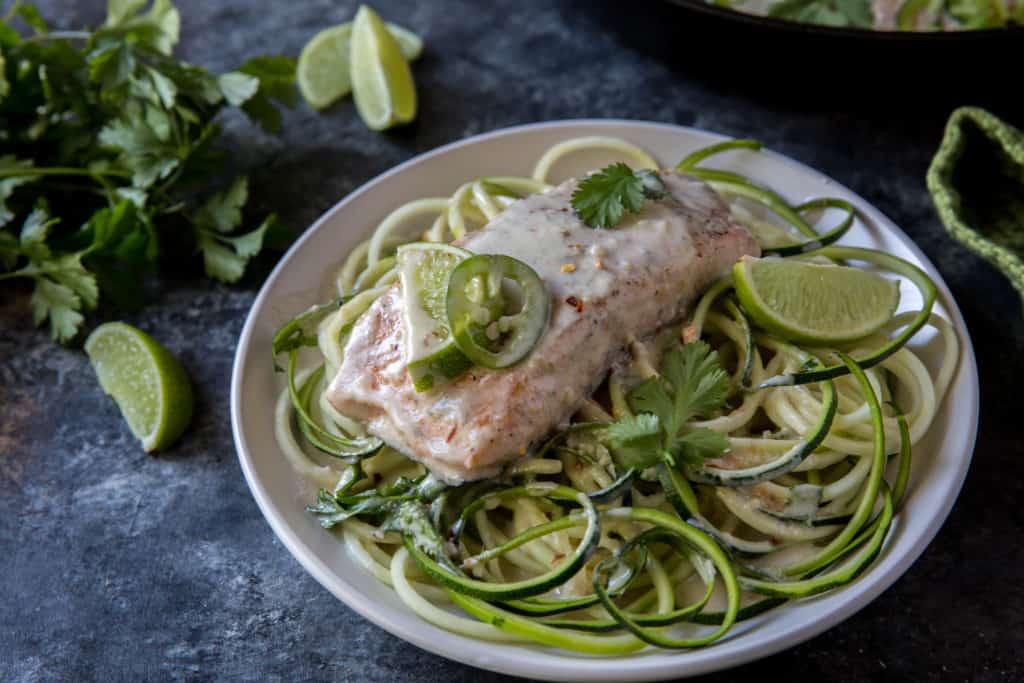 keto salmon keto salmon curry served over zucchini noodles on a white plate
