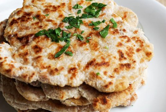 dairy free keto naan stacked on a white plate