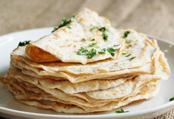 dairy free keto tortillas stacked on a white plate