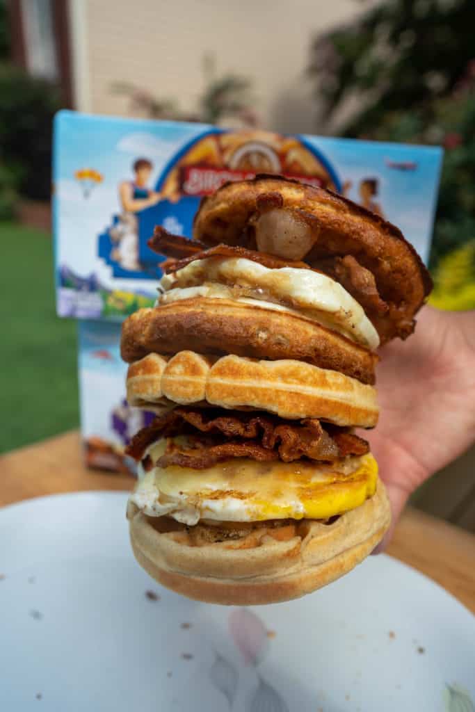 two kete breakfast sandwiches being held stacked on top of each other