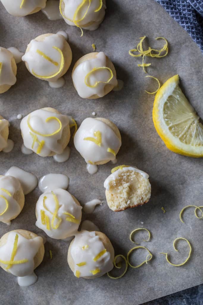 Keto Cookies on a baking tray next to fresh lemon wedges and zest