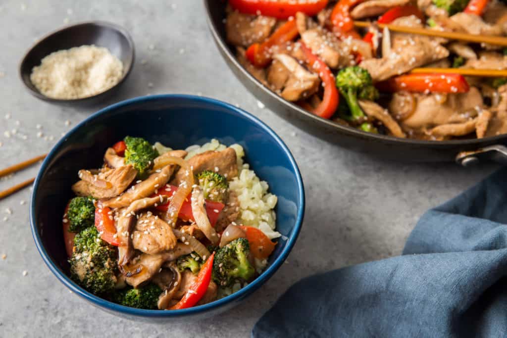 keto chicken stir fry served in a bowl over cauliflower rice