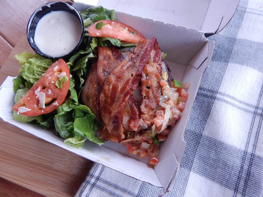 Bunless Burger next to a side salad and ranch