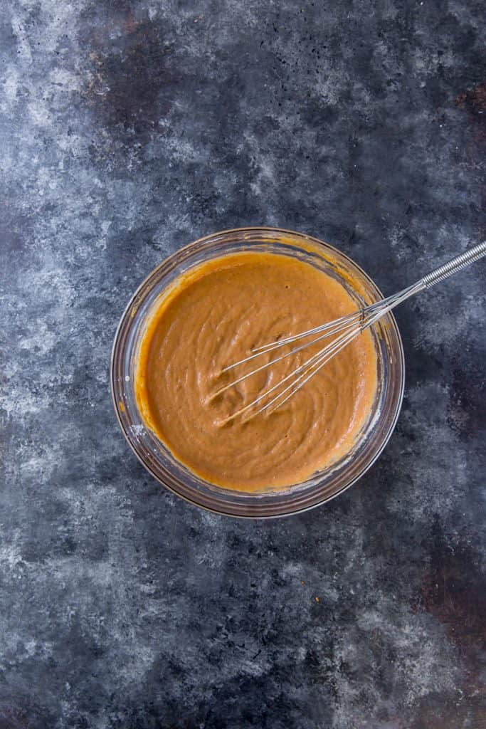 keto pumpkin pie glass bowl with whisk and filling