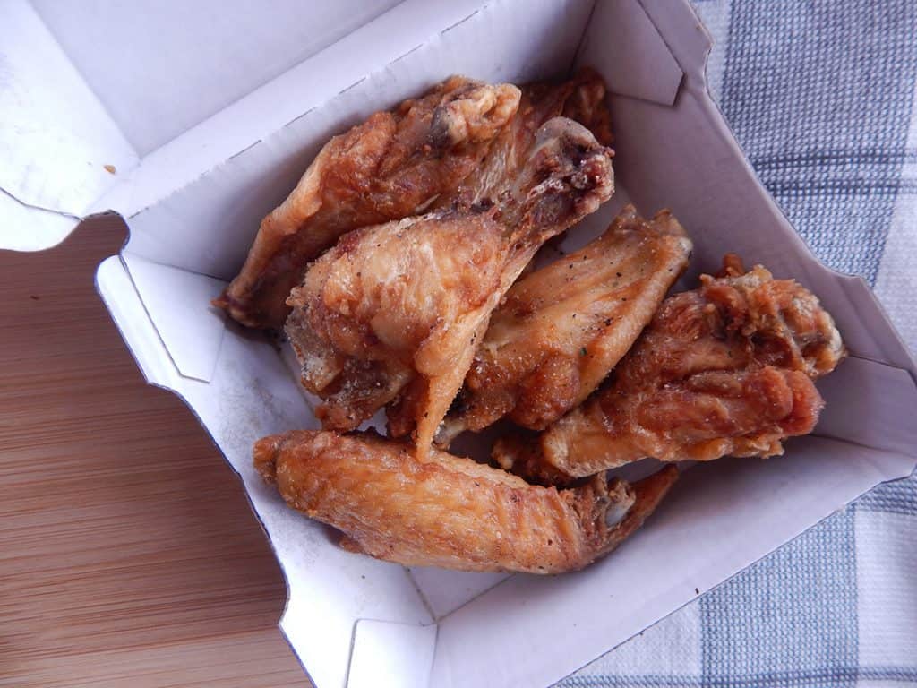 Lemon Pepper herbed wings next to a checkered cloth.