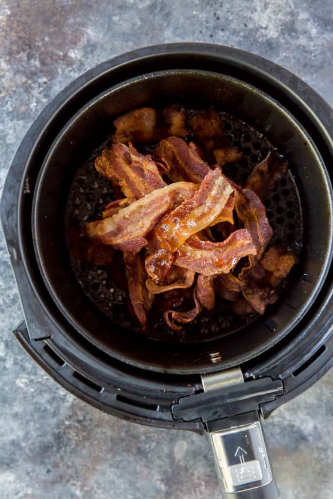 Bacon curing onto one another freshly cooked inside the air fryer