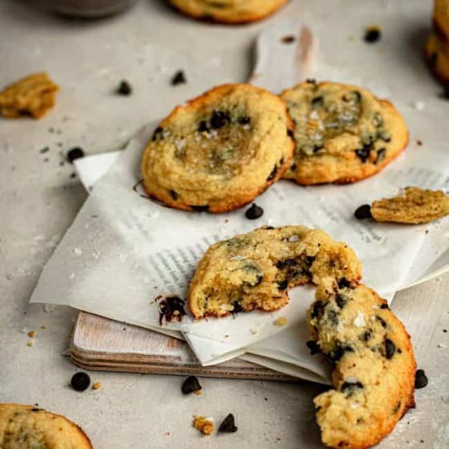 Keto Chocolate Chip Cookies final image of broken cookie on a small cutting board