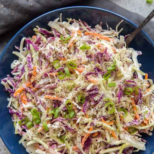keto coleslaw in a bowl with a serving spoon